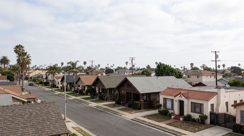 A flat Long Beach street of Craftsman bungalows and small Spanish houses